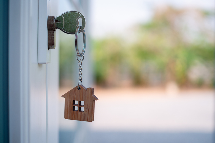 The landlord opened the door with a pending key. Home selling ideas, home mortgage Happy Latin American car salesperson showing cars to a couple shopping at the dealership