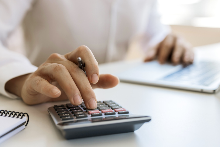 Unrecognizable businessman calculating and planning at office